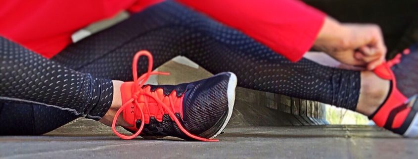 A woman tying her trainers, ready for exercise