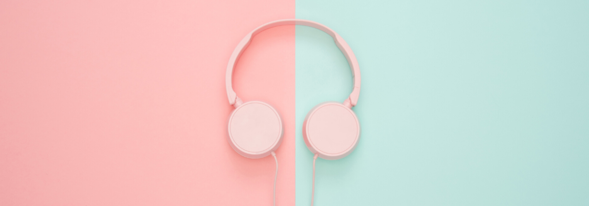 A pair of headphones on a pink and blue background