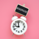 A clock with a sign above it reading menopause