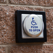 An accessible door push to open button