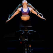 A female Spinning® instructor sitting on her bike