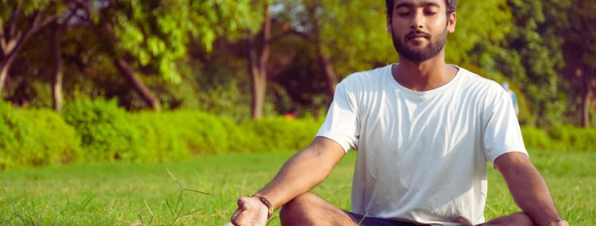 Man meditating outdoors