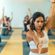 Yoga teacher in group exercise class