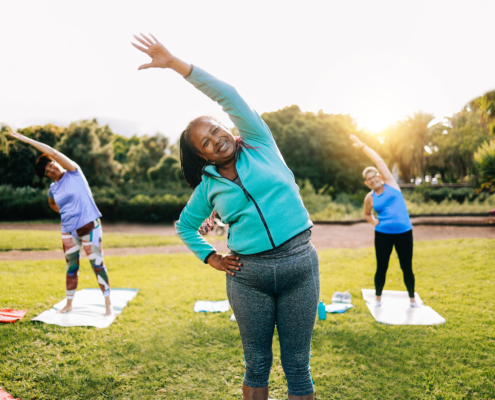 Senior sport people exercising during yoga workout class outdoor at park city - Fitness joyful Elderly lifestyle