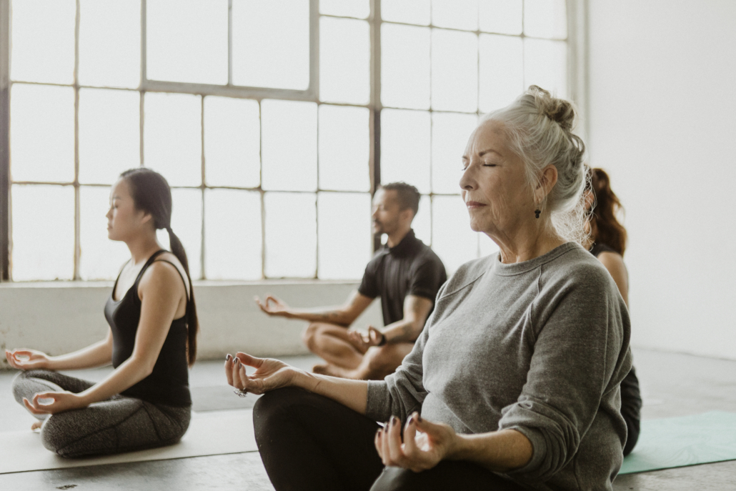Diverse people meditating in a yoga class