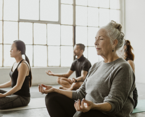 Diverse people meditating in a yoga class