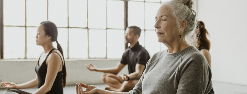 Diverse people meditating in a yoga class