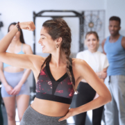 Fitness instructor showing arm muscle