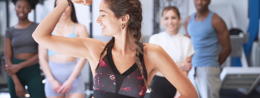 Fitness instructor showing arm muscle