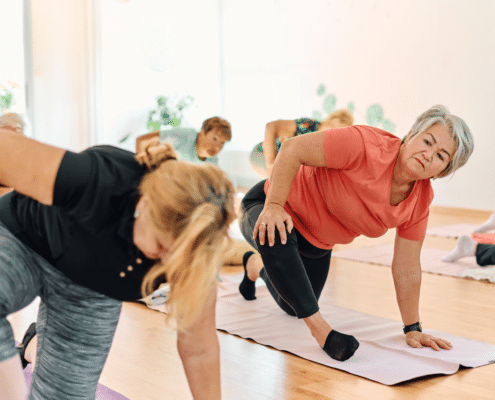 Senior women practicing yoga