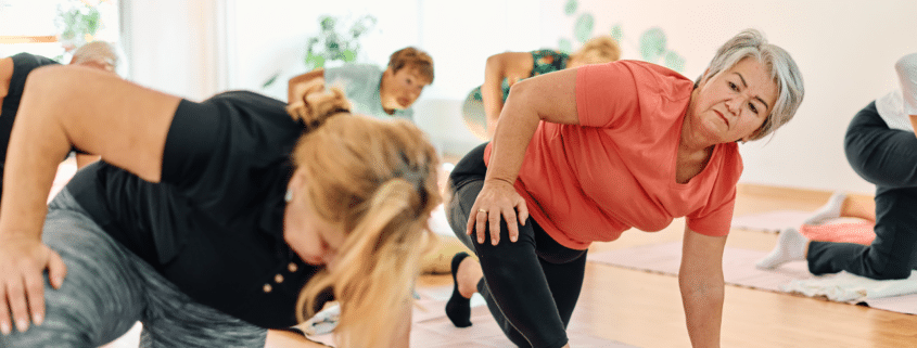 Senior women practicing yoga